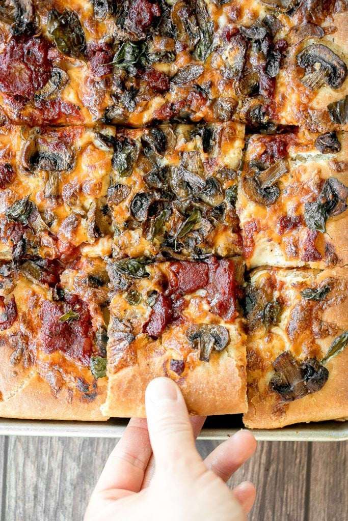 Sheet pan garlic mushroom focaccia pizza with a thick pillowy and crispy crust is topped with sautéed garlic mushrooms, melty mozzarella and lots of basil. | aheadofthyme.com