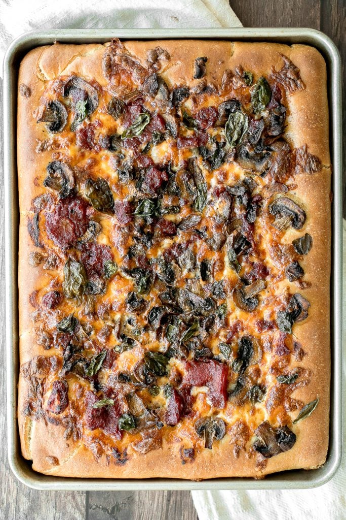 Sheet pan garlic mushroom focaccia pizza with a thick pillowy and crispy crust is topped with sautéed garlic mushrooms, melty mozzarella and lots of basil. | aheadofthyme.com