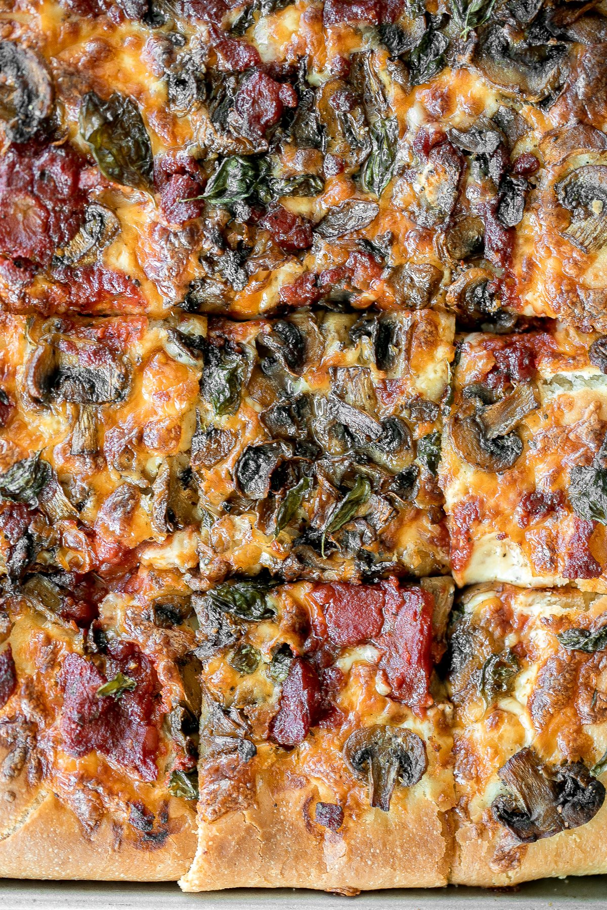 Sheet pan garlic mushroom focaccia pizza with a thick pillowy and crispy crust is topped with sautéed garlic mushrooms, melty mozzarella and lots of basil. | aheadofthyme.com