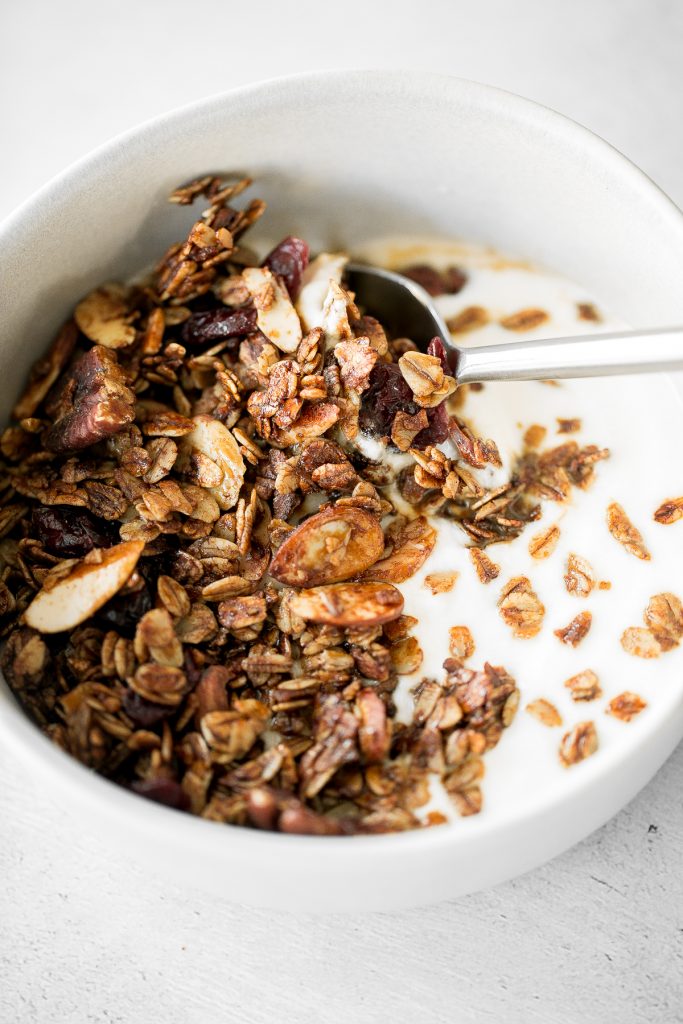 Quick and easy gingerbread granola with nuts, cranberries and warm winter spices is vegan, gluten-free, and refined sugar-free. The best Christmas snack. | aheadofthyme.com