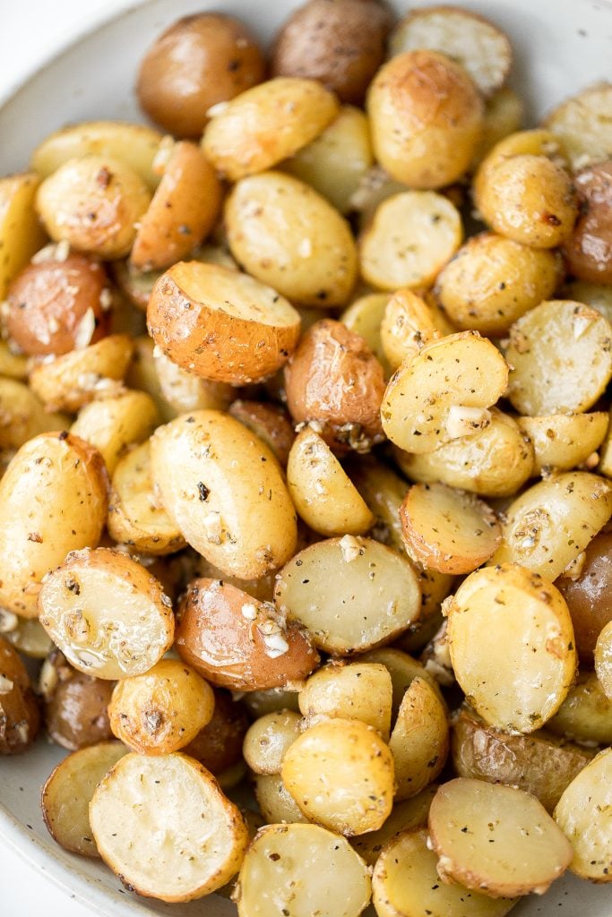 Quick and easy Greek lemon roasted baby potatoes are crispy on the outside and tender inside, packed with a Greek flavour blend of lemon, garlic and herbs. | aheadofthyme.com