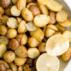 Quick and easy Greek lemon roasted baby potatoes are crispy on the outside and tender inside, packed with a Greek flavour blend of lemon, garlic and herbs. | aheadofthyme.com