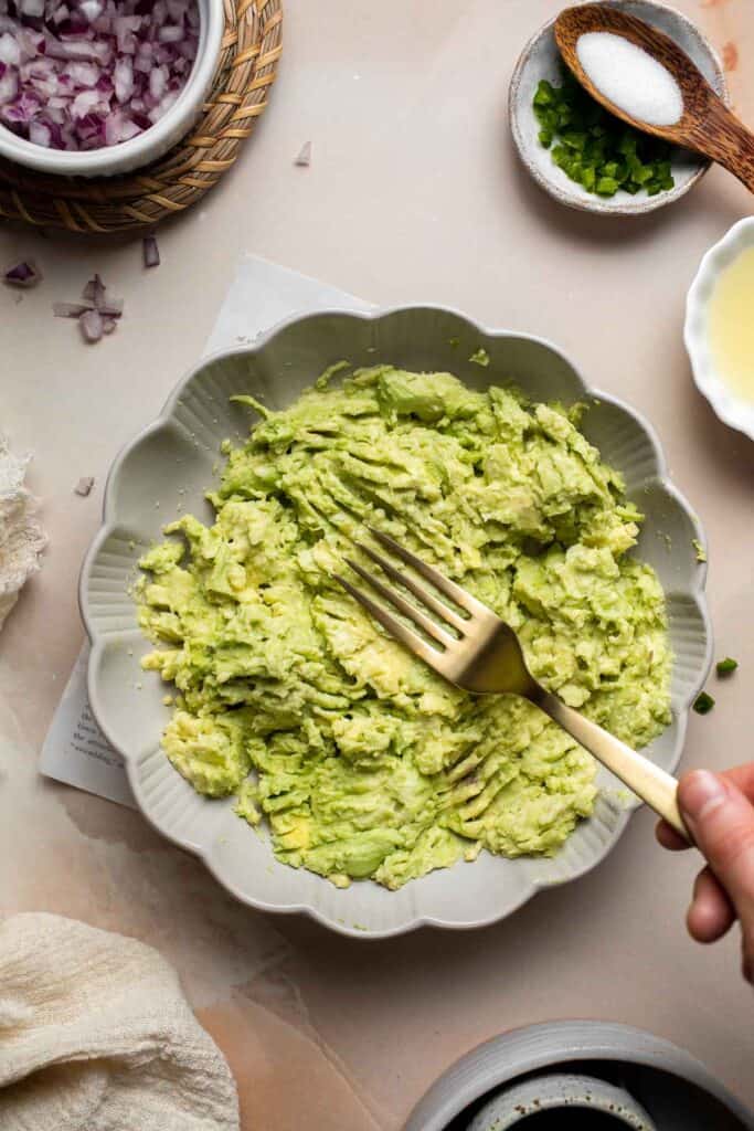 This authentic Guacamole recipe is quick and easy to make at home with just a few simple ingredients and 5 minutes of time. It's fresh and flavorful. | aheadofthyme.com