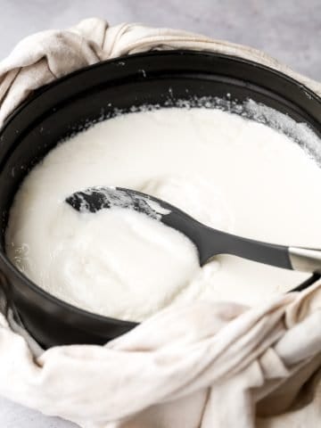 Thick and creamy homemade yogurt is so easy to make at home with just 2 ingredients, a heavy pot, and just a few minutes of actual hands on prep work. | aheadofthyme.com