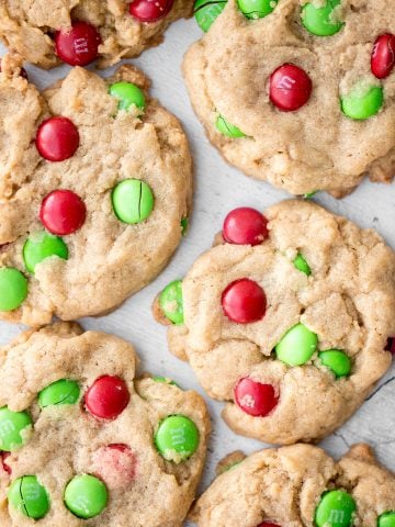 Festive red and green M&M Christmas cookies are super soft and chewy with the crispiest edges. Quick and easy to make in 20 minutes with no chill time. | aheadofthyme.com