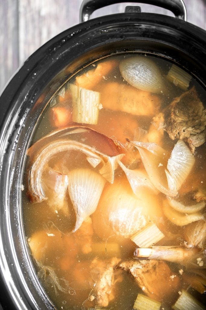 Nutritious wholesome slow cooker bone broth is healing, promotes physical wellness and health, and is easy to make at home. Add it to soups, stews and more. | aheadofthyme.com