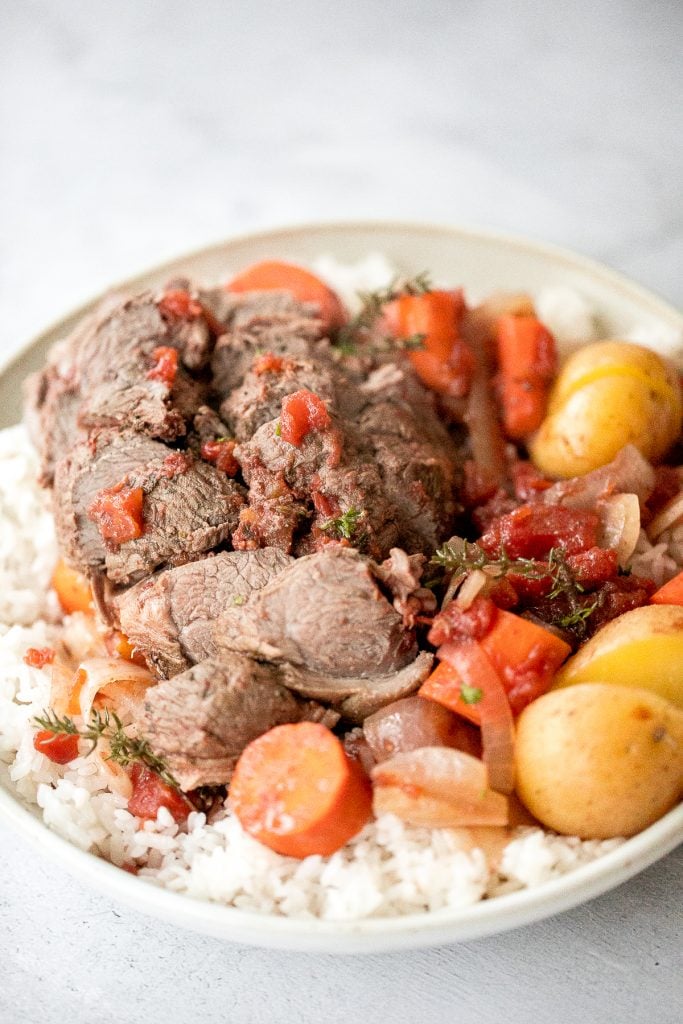 Easy Mediterranean slow cooker leg of lamb with vegetables is succulent, tender, juicy, and flavourful, seasoned with fresh herbs. Prep the crockpot in just 15 minutes. | aheadofthyme.com