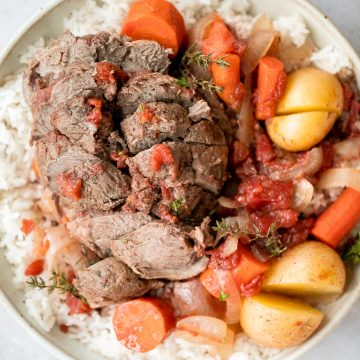 Easy Mediterranean slow cooker leg of lamb with vegetables is succulent, tender, juicy, and flavourful, seasoned with fresh herbs. Prep the crockpot in just 15 minutes. | aheadofthyme.com
