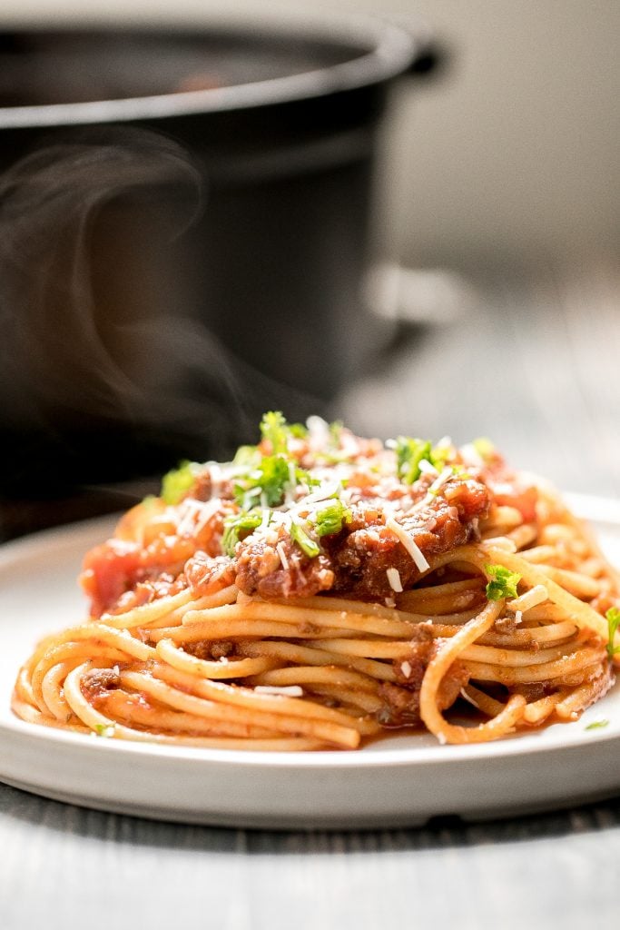 Quick easy spaghetti bolognese with a rich, thick, delicious and flavourful meat sauce is a family favourite ready in 30 minutes. Best weeknight dinner. | aheadofthyme.com