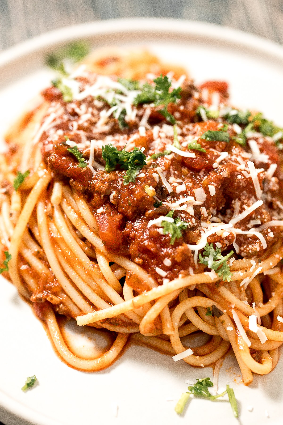 Quick easy spaghetti bolognese with a rich, thick, delicious and flavourful meat sauce is a family favourite ready in 30 minutes. Best weeknight dinner. | aheadofthyme.com