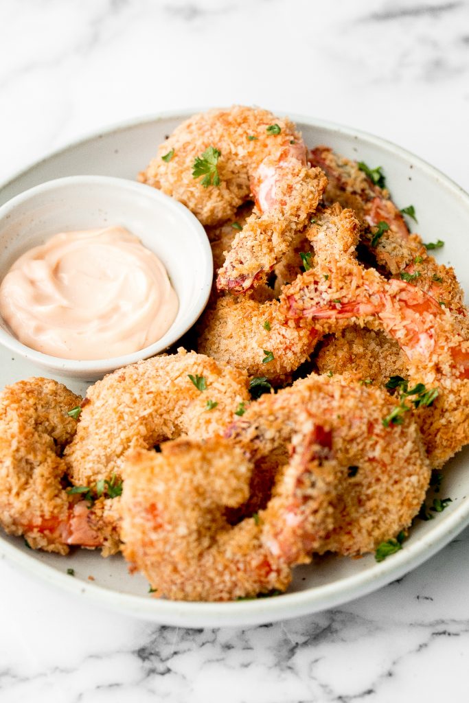 Crispy baked coconut shrimp is a delicious appetizer that is easy to make in 30 minutes. They are more flavourful, tastier and healthier than takeout. | aheadofthyme.com