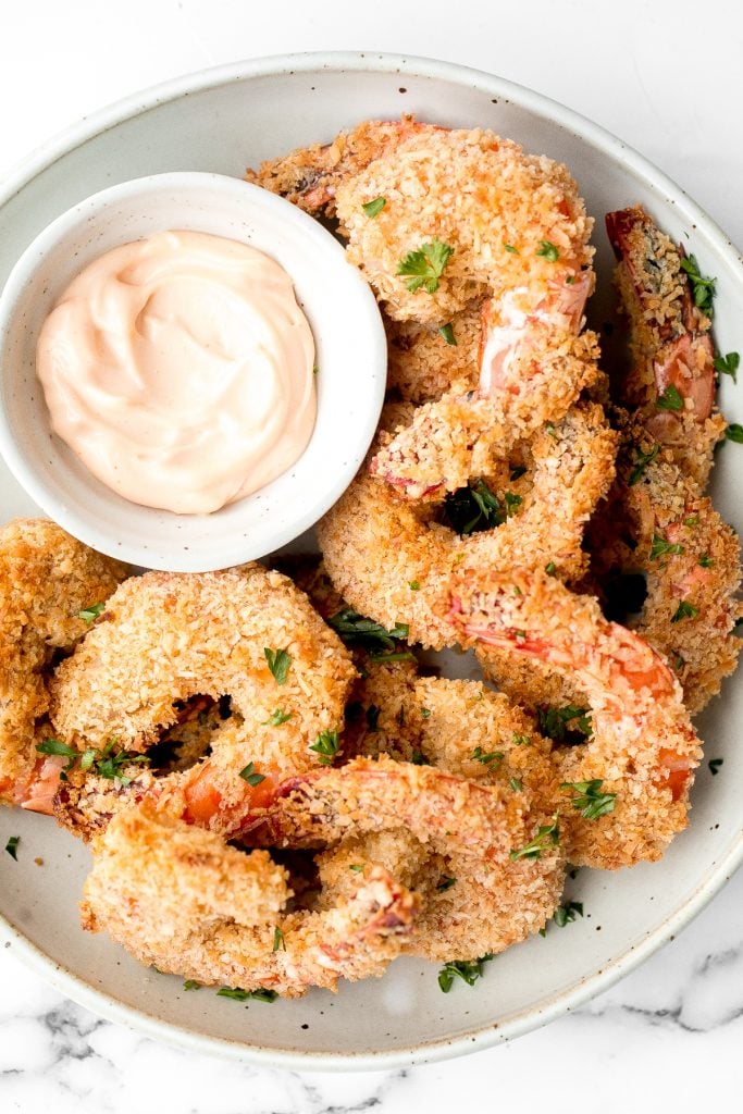 Crispy baked coconut shrimp is a delicious appetizer that is easy to make in 30 minutes. They are more flavourful, tastier and healthier than takeout. | aheadofthyme.com