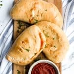 Homemade calzones are delicious little pizza pockets filled with cheese and toppings and baked until golden. This Italian favourite is easy to make at home. | aheadofthyme.com