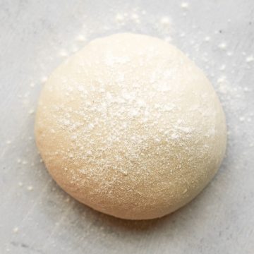 This easy homemade pizza dough makes the best crisp pizza crust that is soft, airy, chewy and flavourful. It's a perfect recipe for beginners. | aheadofthyme.com