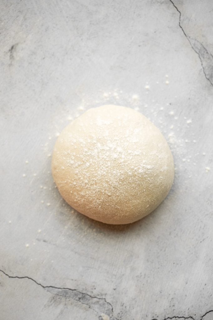 This easy homemade pizza dough makes the best crisp pizza crust that is soft, airy, chewy and flavourful. It's a perfect recipe for beginners. | aheadofthyme.com