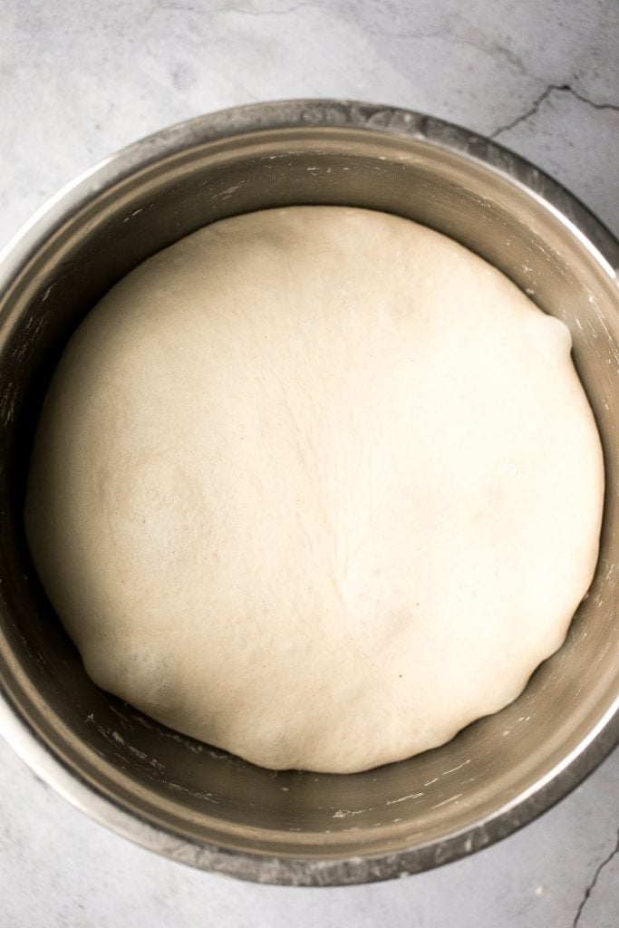 This easy homemade pizza dough makes the best crisp pizza crust that is soft, airy, chewy and flavourful. It's a perfect recipe for beginners. | aheadofthyme.com