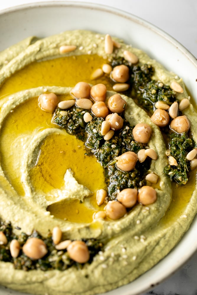 Smooth and creamy pesto hummus is a healthy, delicious and flavourful dip that is easy to make in just 5 minutes. It's vegan and gluten-free. | aheadofthyme.com