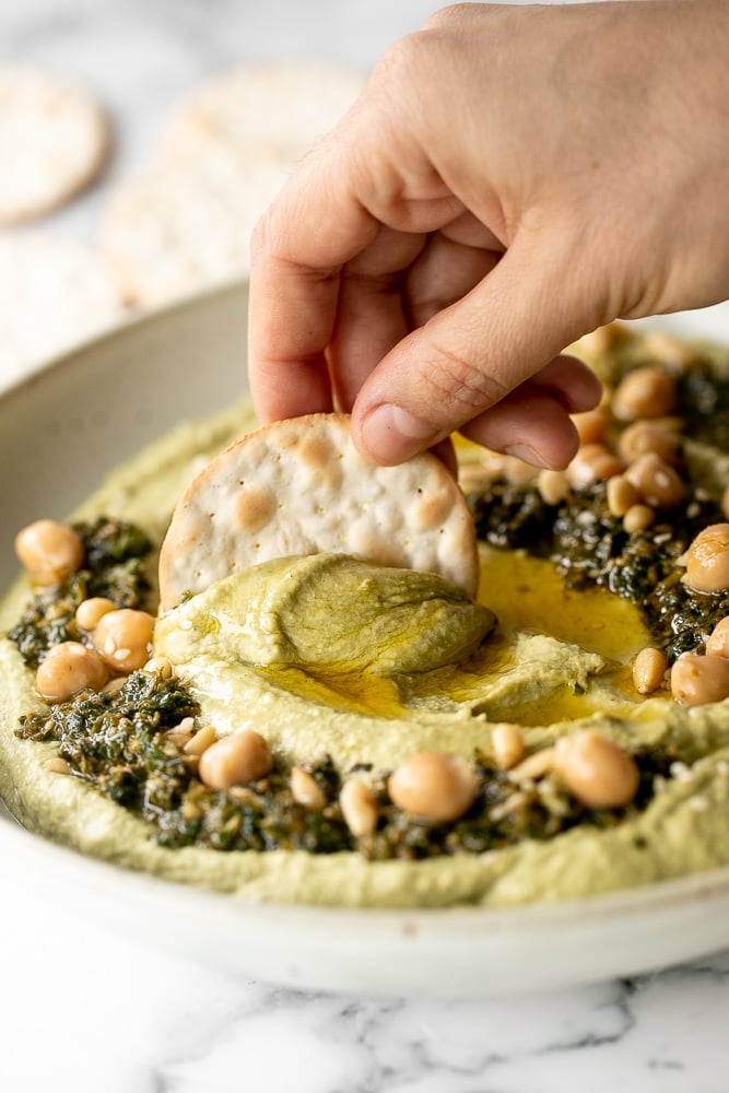 Smooth and creamy pesto hummus is a healthy, delicious and flavourful dip that is easy to make in just 5 minutes. It's vegan and gluten-free. | aheadofthyme.com