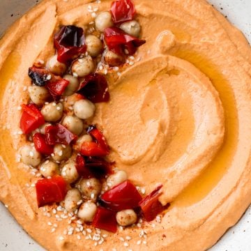 Smooth creamy roasted red pepper hummus is a delicious, flavourful, vegan + gluten-free dip. This healthy appetizer is easy to make with a few ingredients. | aheadofthyme.com