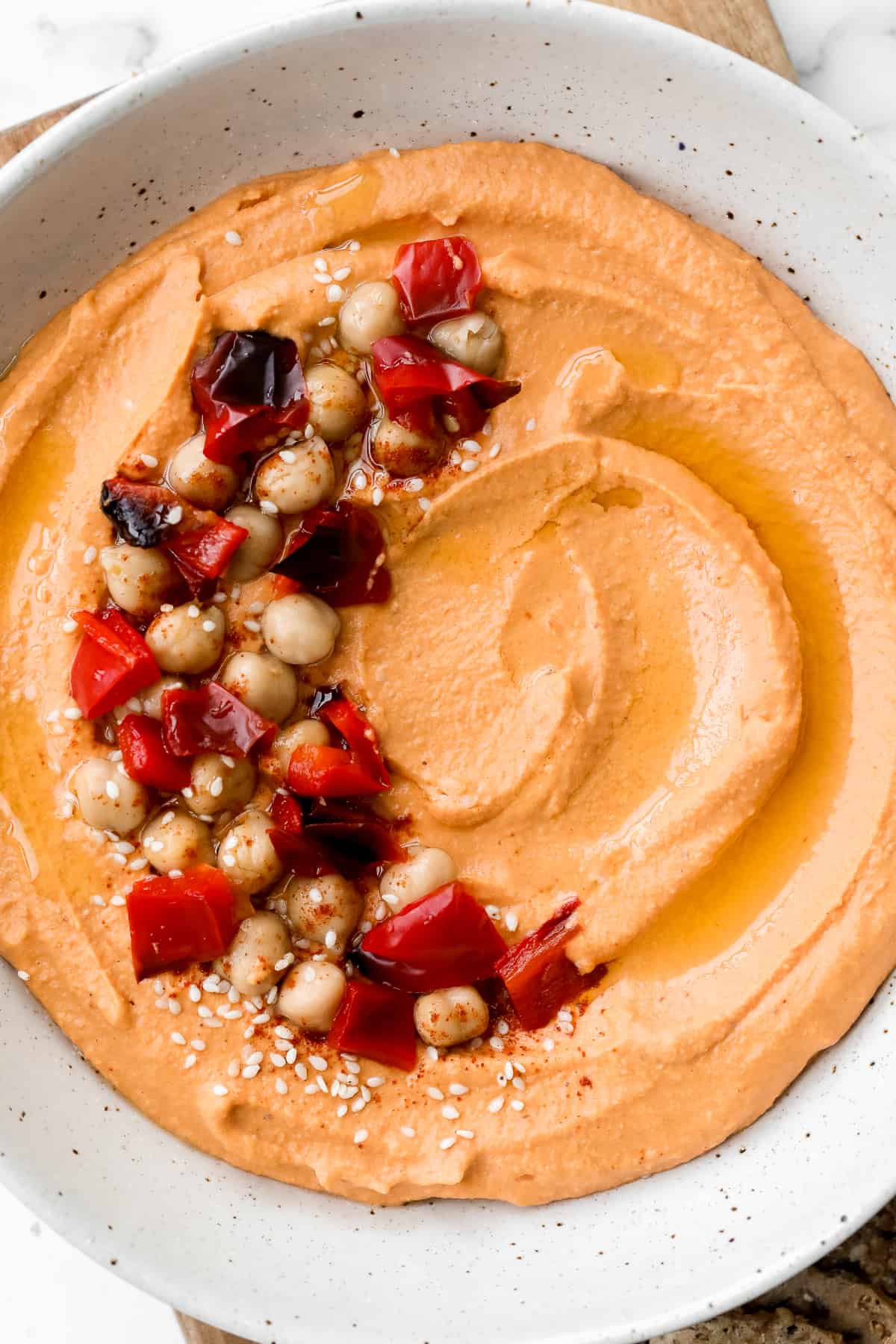 Smooth creamy roasted red pepper hummus is a delicious, flavourful, vegan + gluten-free dip. This healthy appetizer is easy to make with a few ingredients. | aheadofthyme.com