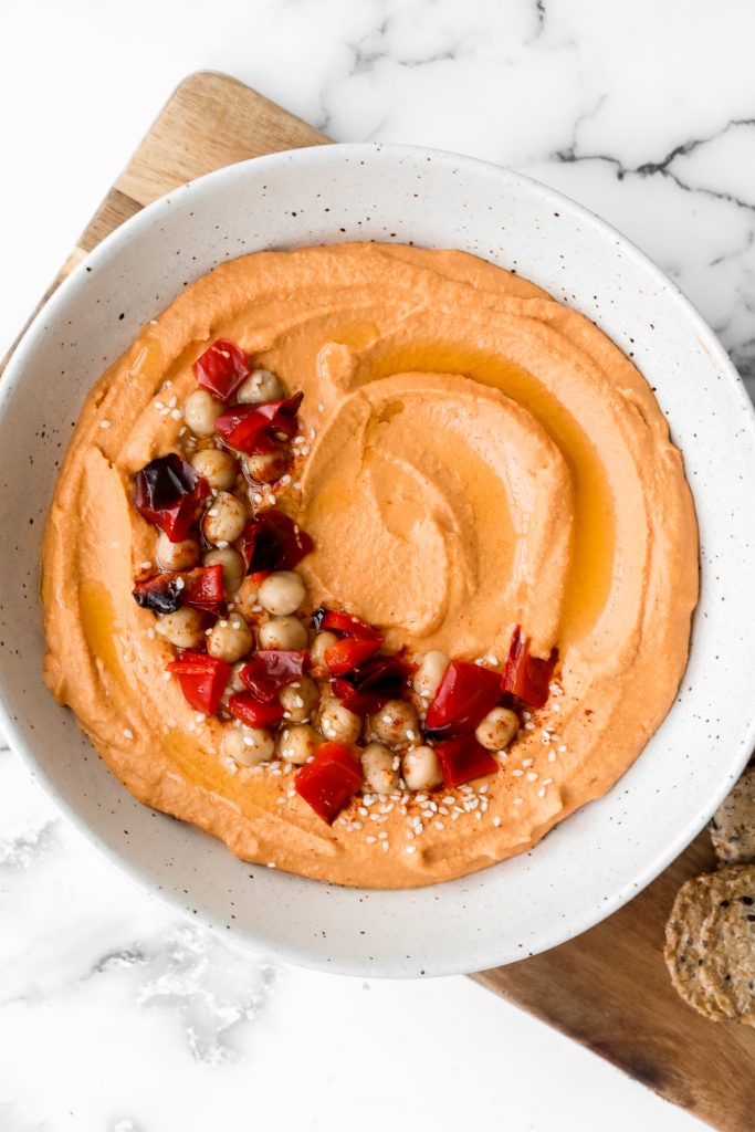 Smooth creamy roasted red pepper hummus is a delicious, flavourful, vegan + gluten-free dip. This healthy appetizer is easy to make with a few ingredients. | aheadofthyme.com