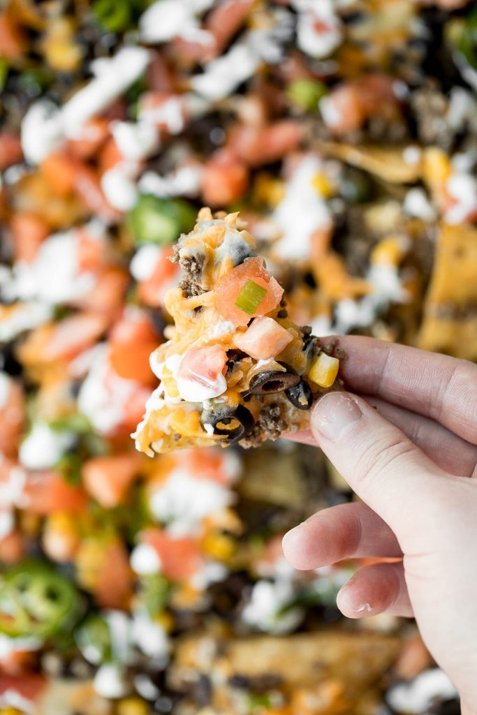 Oven-baked loaded sheet pan nachos are a crowd pleaser for an easy weeknight dinner or an addicting appetizer to serve on game day. | aheadofthyme.com