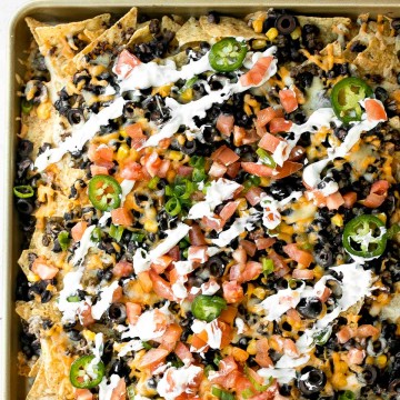 Oven-baked loaded sheet pan nachos are a crowd pleaser for an easy weeknight dinner or an addicting appetizer to serve on game day. | aheadofthyme.com