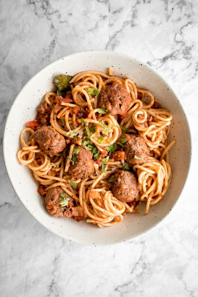 Quick and easy spaghetti and meatballs is delicious, rich, comforting with tender beef meatballs simmered in a savoury tomato sauce. Make it in 30 minutes. | aheadofthyme.com