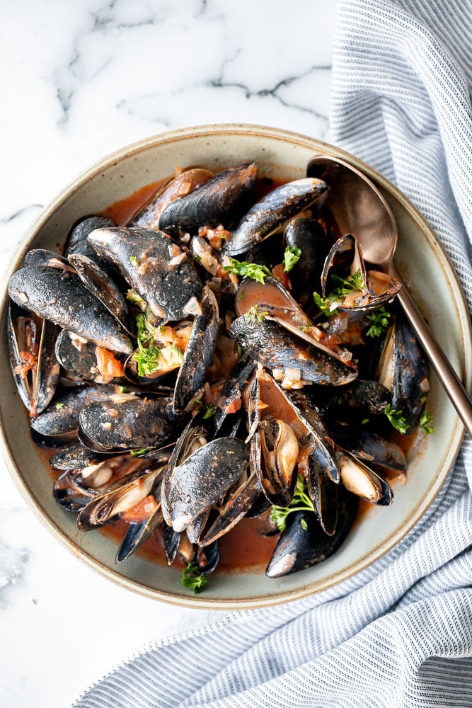 Steamed mussels in tomato sauce is an impressive restaurant-quality dish that is so quick and easy to make at home in less than 25 minutes. | aheadofthyme.com