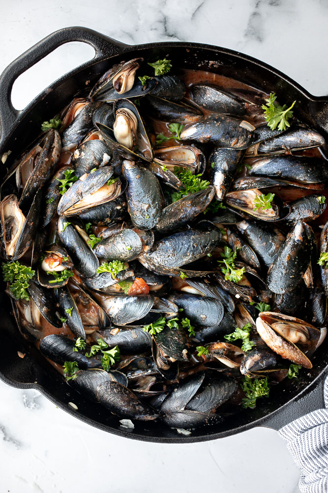 Steamed mussels in tomato sauce is an impressive restaurant-quality dish that is so quick and easy to make at home in less than 25 minutes. | aheadofthyme.com