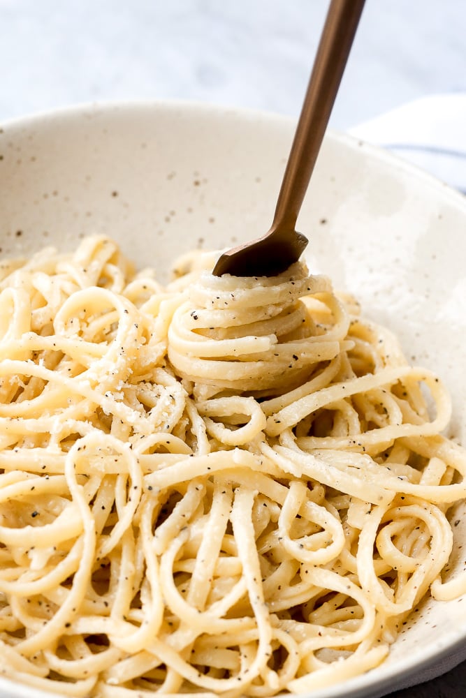 Cacio e pepe is a simple, authentic Italian pasta dish made with just four ingredients in 20 minutes. It's delicious, flavourful and easy to make. | aheadofthyme.com