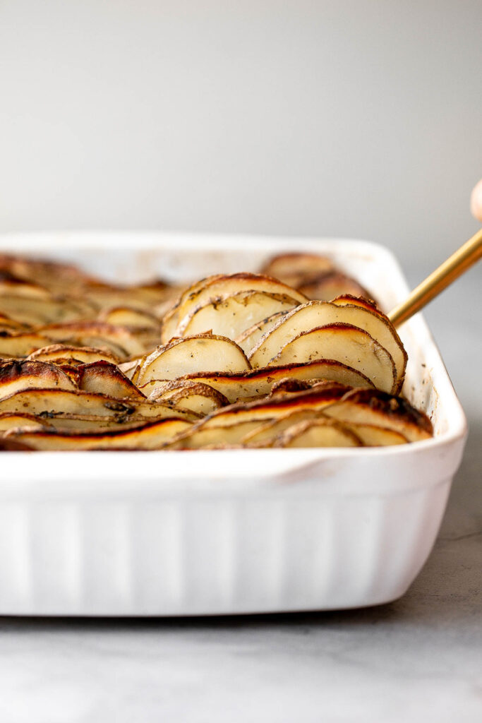Crispy leaf potatoes are a delicious potato side dish made with layers of buttery, sliced potatoes that crisp up when baked. The perfect side dish. | aheadofthyme.com