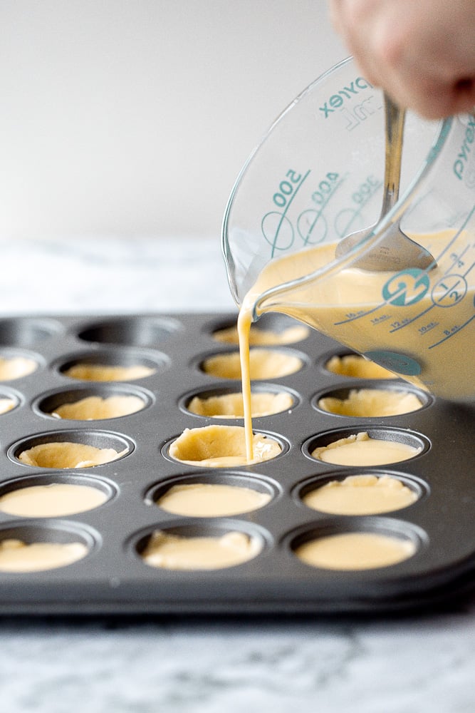 Mini egg tarts with a flaky buttery crust and silky smooth rich egg custard filling are a delicious Hong Kong pastry served as dessert with dim sum. | aheadofthyme.com