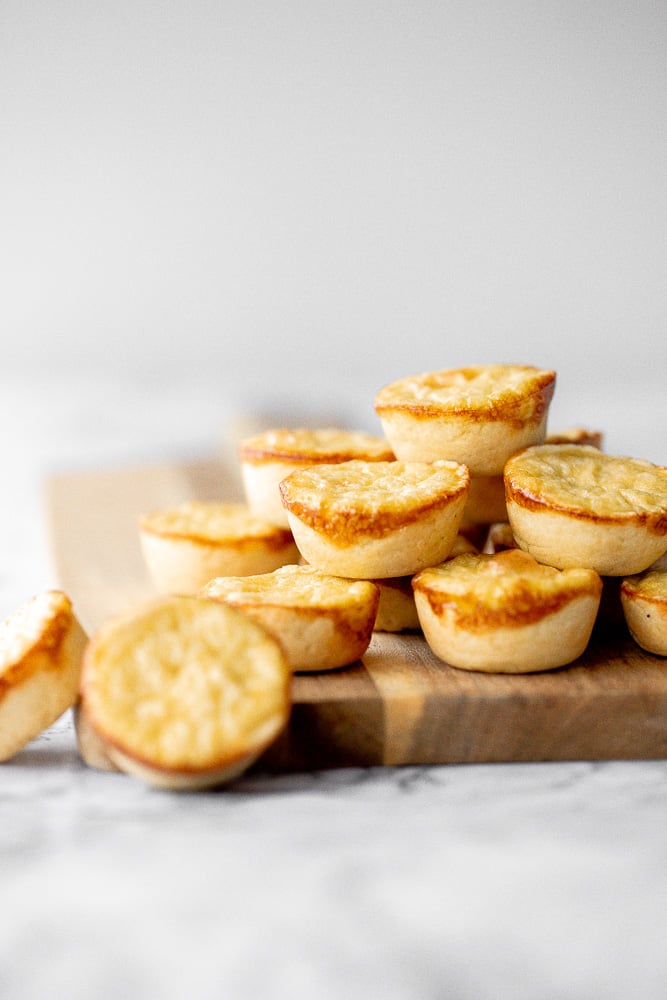 Mini egg tarts with a flaky buttery crust and silky smooth rich egg custard filling are a delicious Hong Kong pastry served as dessert with dim sum. | aheadofthyme.com