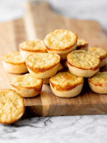 Mini egg tarts with a flaky buttery crust and silky smooth rich egg custard filling are a delicious Hong Kong pastry served as dessert with dim sum. | aheadofthyme.com