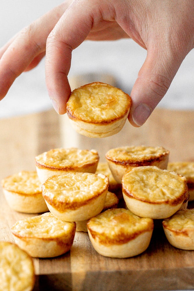 Mini egg tarts with a flaky buttery crust and silky smooth rich egg custard filling are a delicious Hong Kong pastry served as dessert with dim sum. | aheadofthyme.com