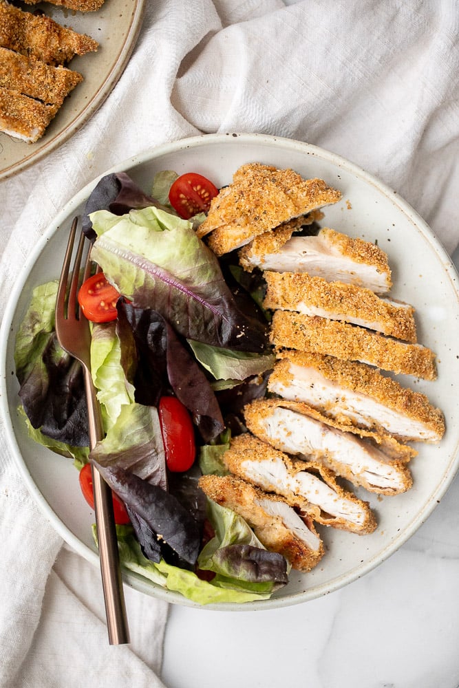 Baked parmesan crusted chicken is breaded in a herby parmesan breadcrumb mixture and baked until crispy perfection. So flavourful and delicious. | aheadofthyme.com