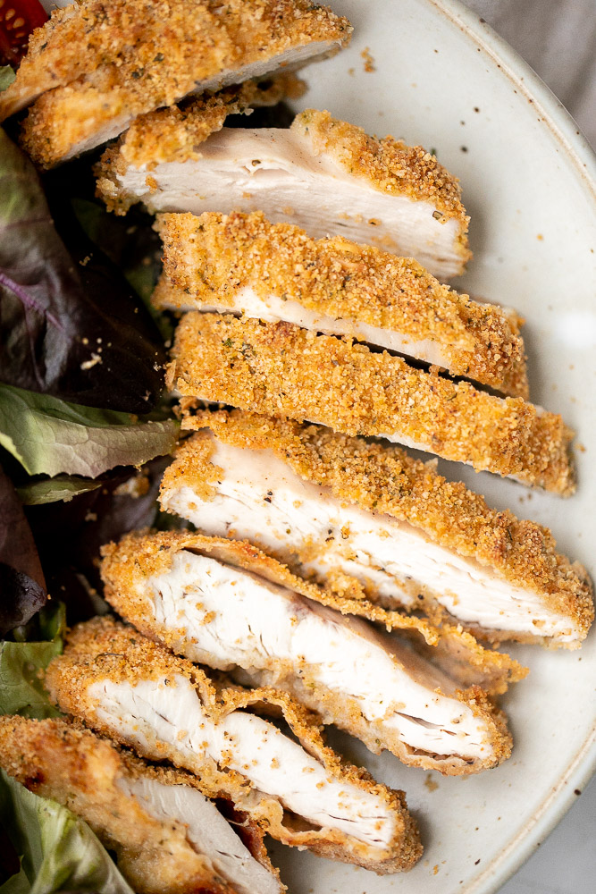 Baked parmesan crusted chicken is breaded in a herby parmesan breadcrumb mixture and baked until crispy perfection. So flavourful and delicious. | aheadofthyme.com