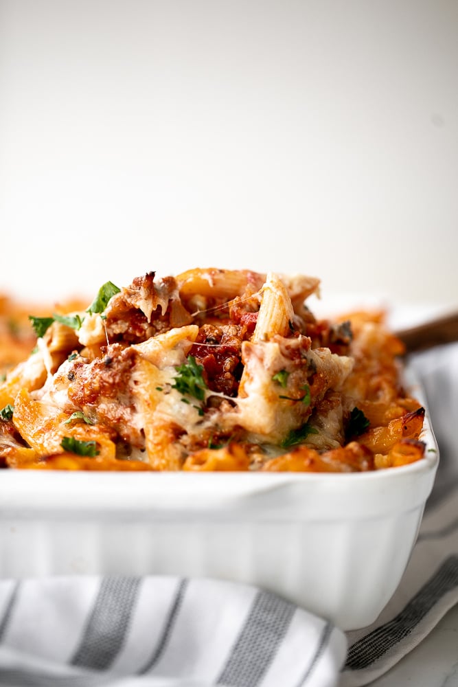 Pasta bake with sausage (baked ziti) is a lazy day lasagna with layers of pasta tossed in a rich meat sauce, layered with mozzarella, and baked. | aheadofthyme.com