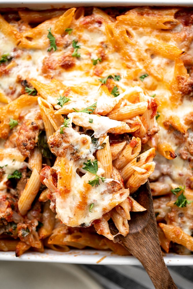 Pasta bake with sausage (baked ziti) is a lazy day lasagna with layers of pasta tossed in a rich meat sauce, layered with mozzarella, and baked. | aheadofthyme.com