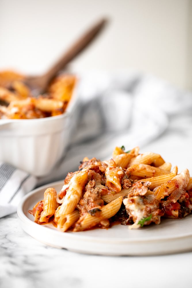 Pasta bake with sausage (baked ziti) is a lazy day lasagna with layers of pasta tossed in a rich meat sauce, layered with mozzarella, and baked. | aheadofthyme.com