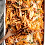 Pasta bake with sausage (baked ziti) is a lazy day lasagna with layers of pasta tossed in a rich meat sauce, layered with mozzarella, and baked. | aheadofthyme.com