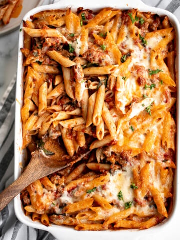 Pasta bake with sausage (baked ziti) is a lazy day lasagna with layers of pasta tossed in a rich meat sauce, layered with mozzarella, and baked. | aheadofthyme.com