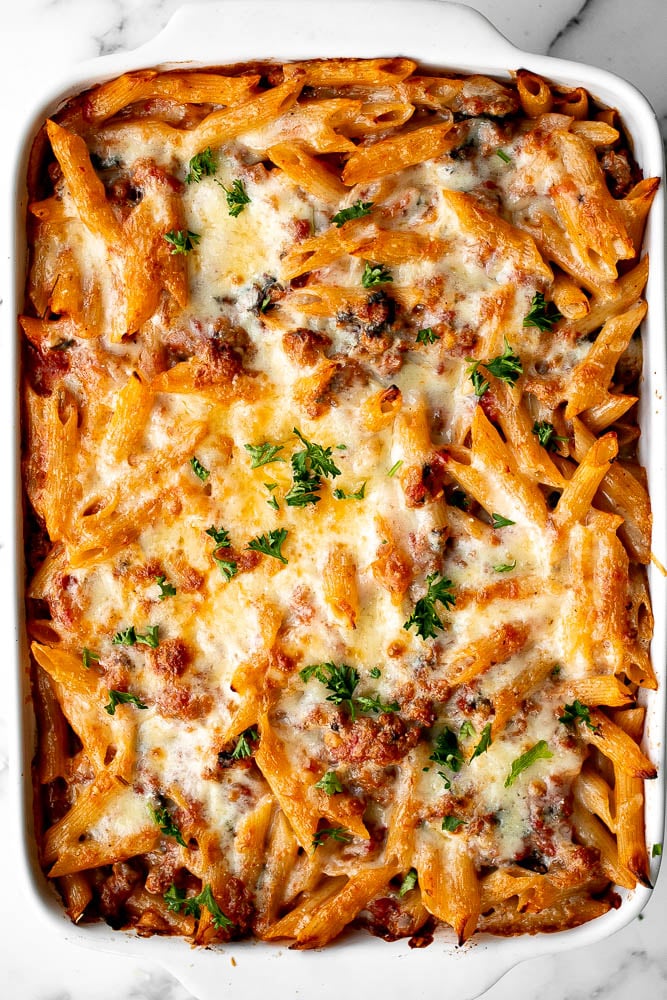 Pasta bake with sausage (baked ziti) is a lazy day lasagna with layers of pasta tossed in a rich meat sauce, layered with mozzarella, and baked. | aheadofthyme.com