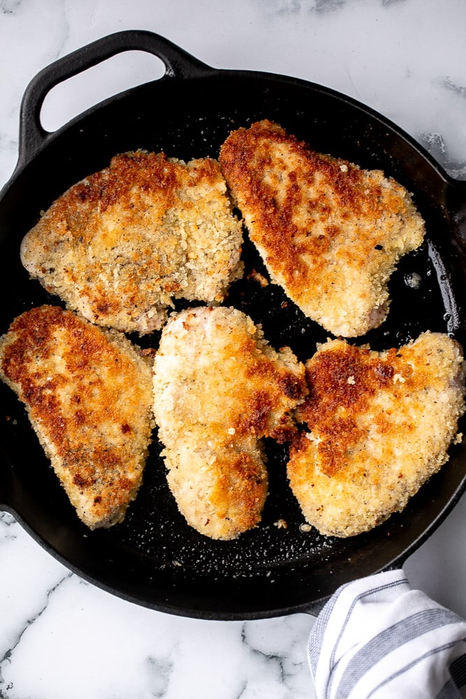 Baked turkey parmesan with a delicious, crispy, breaded coating covered in a rich homemade tomato sauce and topped with melted mozzarella and parmesan. | aheadofthyme.com