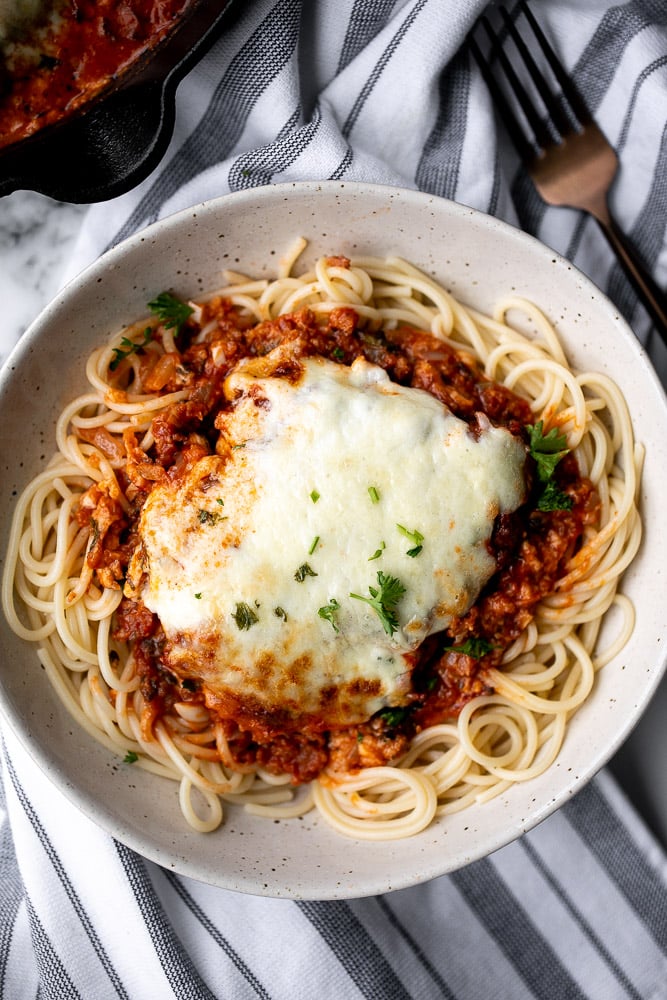 Baked turkey parmesan with a delicious, crispy, breaded coating covered in a rich homemade tomato sauce and topped with melted mozzarella and parmesan. | aheadofthyme.com