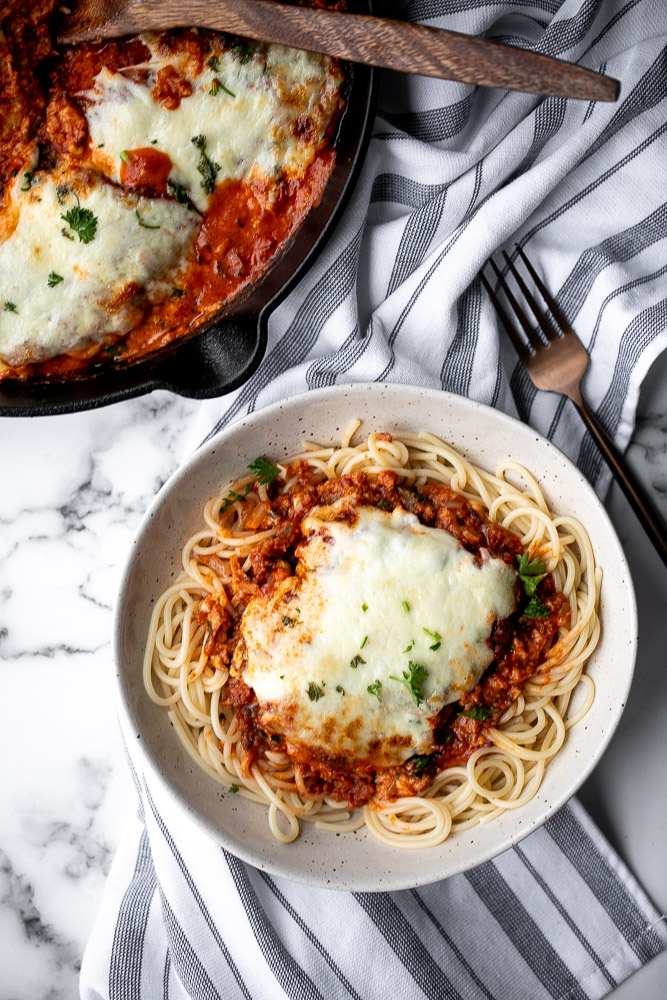 Baked turkey parmesan with a delicious, crispy, breaded coating covered in a rich homemade tomato sauce and topped with melted mozzarella and parmesan. | aheadofthyme.com