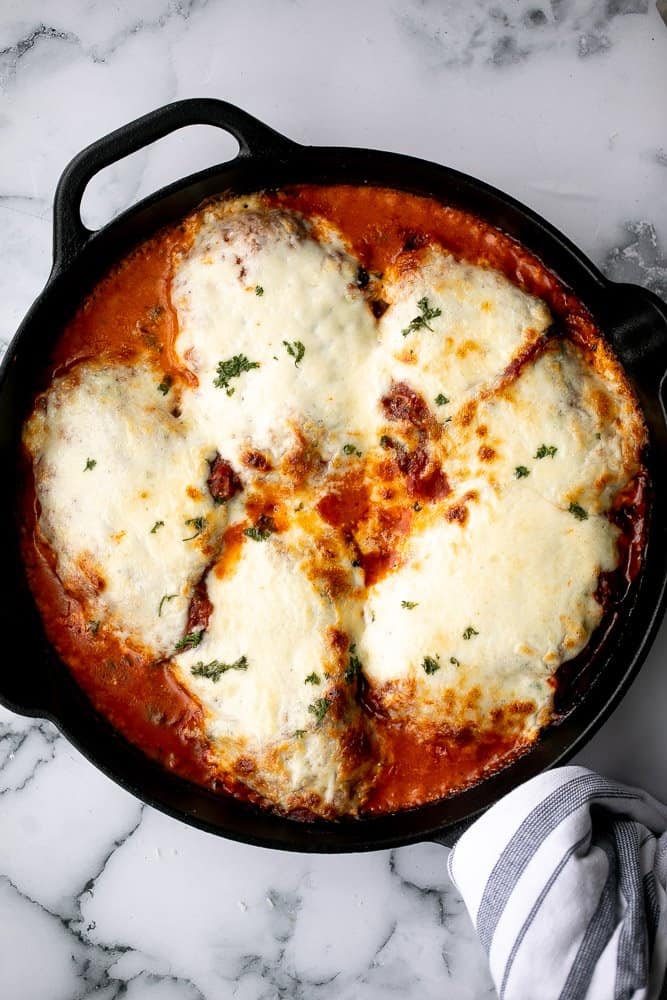 Baked turkey parmesan with a delicious, crispy, breaded coating covered in a rich homemade tomato sauce and topped with melted mozzarella and parmesan. | aheadofthyme.com