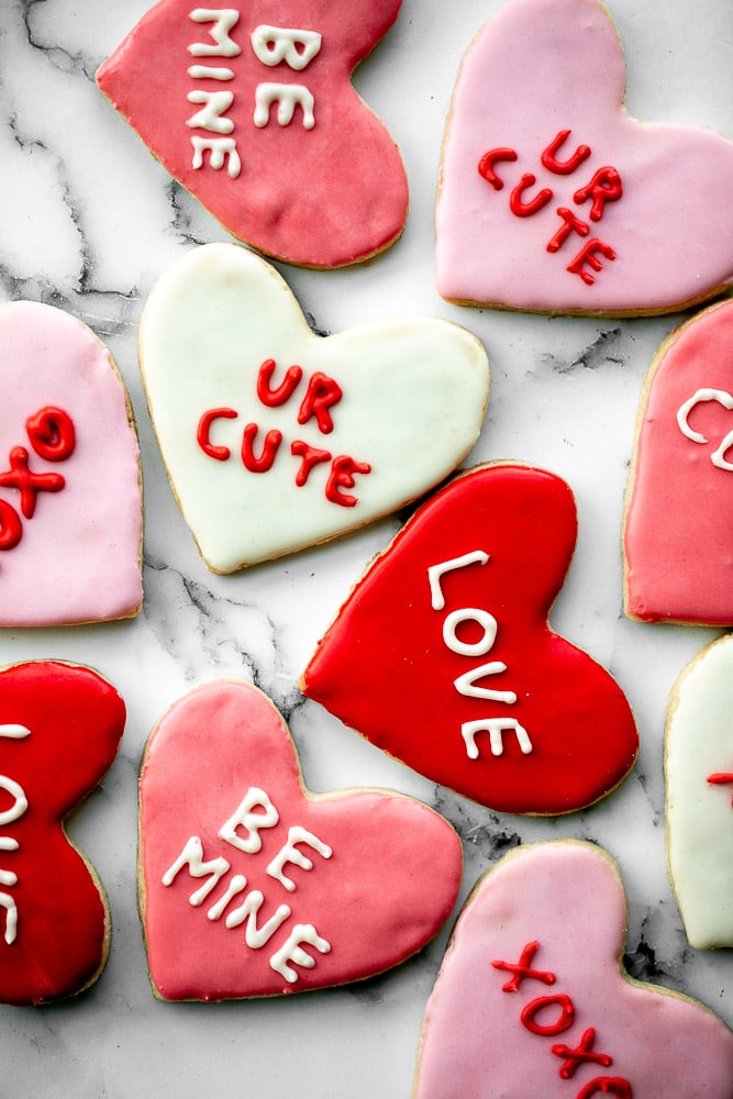 Valentine's Day heart sugar cookies are crisp on the outside, soft inside, and made festive with red and pink royal icing decorated on top. | aheadofthyme.com