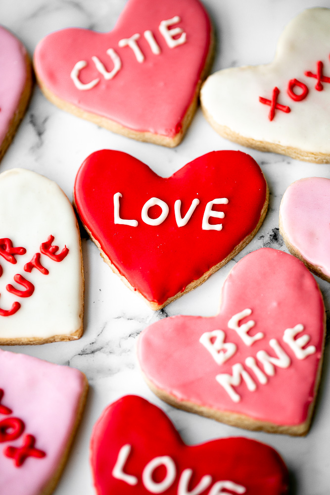 Valentine's Day heart sugar cookies are crisp on the outside, soft inside, and made festive with red and pink royal icing decorated on top. | aheadofthyme.com